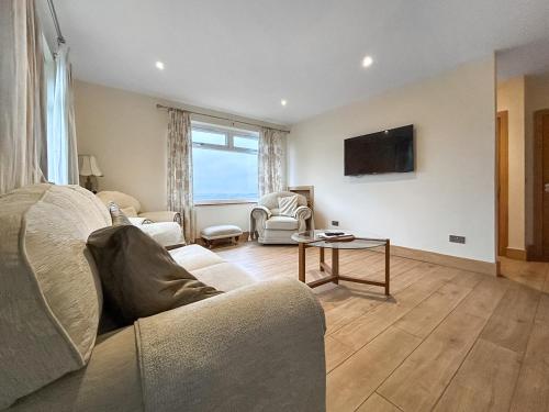 a living room with a couch and a table at The Annexe - Uk51362 in Dollar