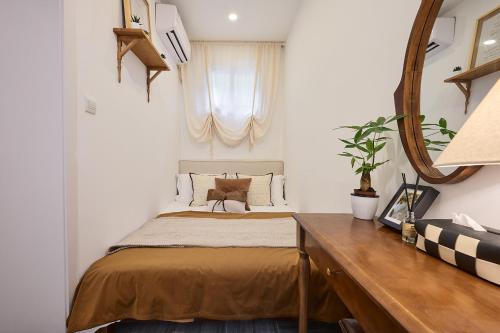 a bedroom with a bed and a mirror at Shanghai Hills&Well-time MCM Family loft Near Line2 and line13 West Nanjing Road in Shanghai