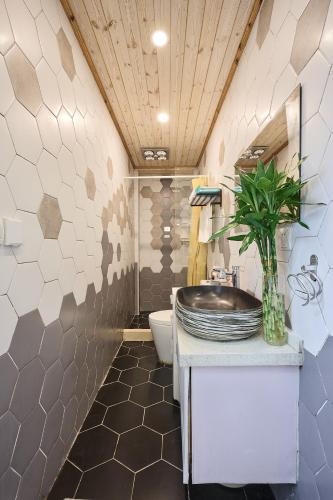 a bathroom with a sink and a toilet at Shanghai Hills&Well-time MCM Family loft Near Line2 and line13 West Nanjing Road in Shanghai