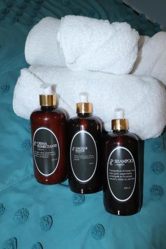 two bottles of soap and a pile of towels at Hacienda Casa de Piedra in Tlacolula de Matamoros