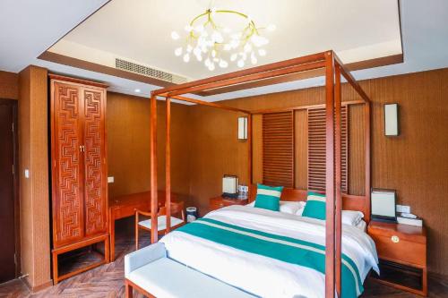 a bedroom with a large bed and a chandelier at Book and Bed-ChongMing in Shanghai