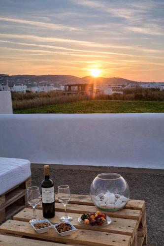 a table with two wine glasses and a bowl of food at Pounda Breeze in Pounda