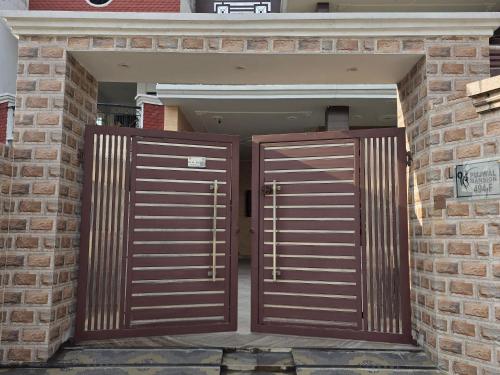 two brown doors in a brick building at StayStudio in Jammu