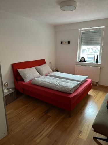 a bedroom with a red bed in a room at alisa in Srebrenik