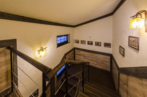 a room with stairs and pictures on the wall at Chalet CrepDeChine Hotel in Bukovel
