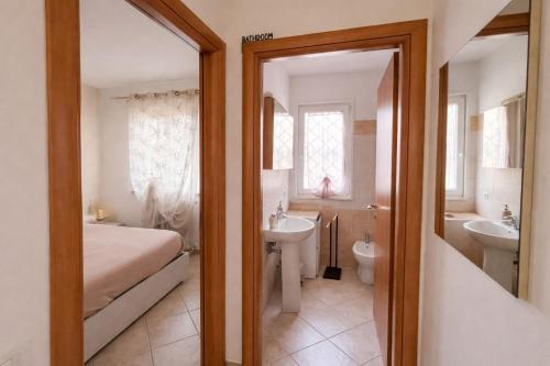 a bathroom with a bed and a sink and a toilet at Il Borghetto in Ciampino