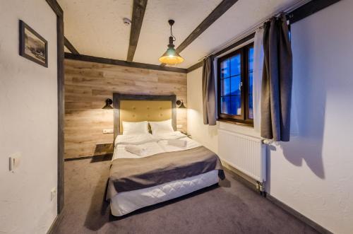 a bedroom with a bed in a room with a window at Chalet CrepDeChine Hotel in Bukovel