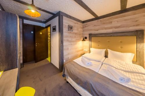 a bedroom with a large bed in a room at Chalet CrepDeChine Hotel in Bukovel