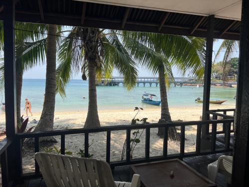 a view of the beach from a resort with palm trees at Maya Seaview Chalet, Coral Bay Perhentian Island in Perhentian Island