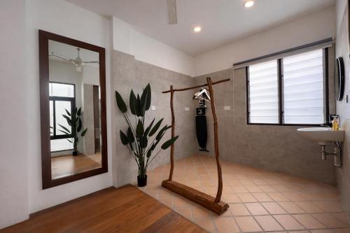 a bathroom with a sink and a mirror at Courtyard by Heritage Row in George Town