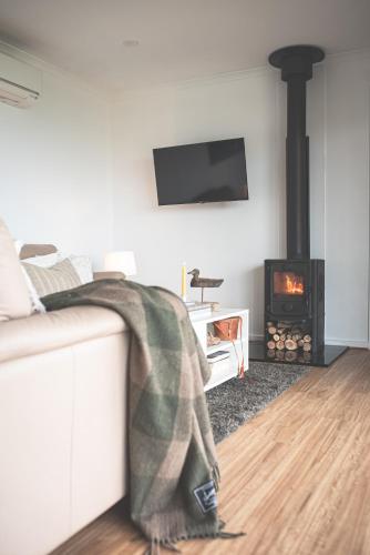a living room with a couch and a fireplace at kentonviewsestate in Gumeracha