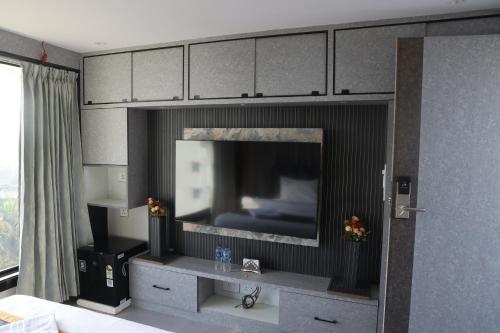 a room with a flat screen tv in a living room at Hotel SERENE PRAIA in Visakhapatnam