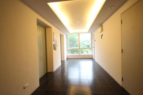 an empty hallway with a large window and a ceiling at Dcondo Kathu Patong Phuket by Jack in Kathu