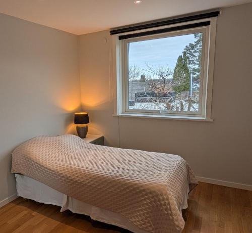 a bedroom with a bed and a window at Exclusive villa with a stunning view in Sigtuna
