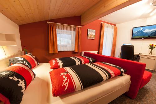 a living room with a couch with pillows on it at Appartement Gimpl in Fusch an der Glocknerstraße
