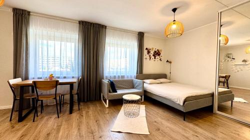 a bedroom with a bed and a table and a dining room at Studio apartment in Pärnu