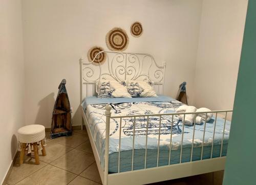 a bedroom with a white bed with blue sheets at Mare Monte Suites 2 in Parasporos