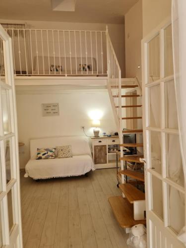 a bedroom with a bed and stairs in a room at Casa Bruna in San Teodoro