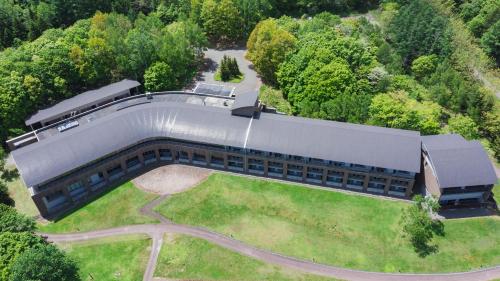 an overhead view of a large building with a yard at Furano Hotel 富良野ホテル in Furano