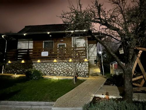 a house with lights on the front of it at night at Lianne Apartman in Miskolctapolca
