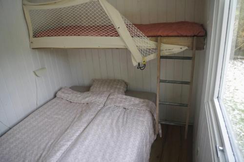 a small room with two bunk beds in it at Holiday Home in Thyholm