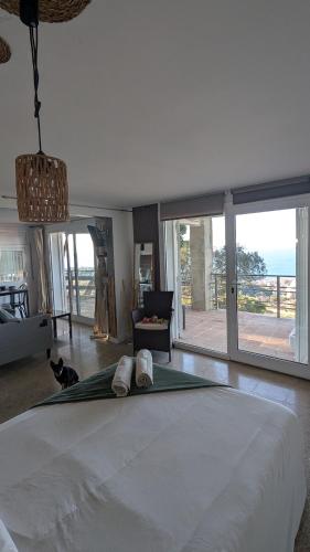 a bedroom with a large bed and a large window at Tutto Passa Lloret in Lloret de Mar