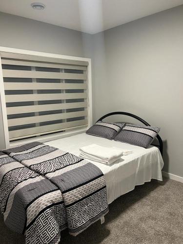 ein Schlafzimmer mit einem Bett und einem großen Fenster in der Unterkunft Authentic Suite - New Cozy 1 BR 1 Bath, 2 Guest in 