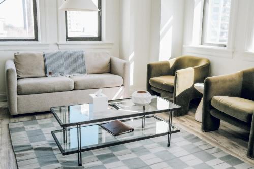 a living room with a couch and a coffee table at The Neighborhood Hotel - Lincoln Park 501 - Three Bedroom Penthouse in Chicago