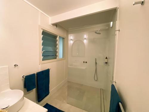a bathroom with a shower and a sink at Sanctuary Spaces - Wategoes Beach Shack in Byron Bay