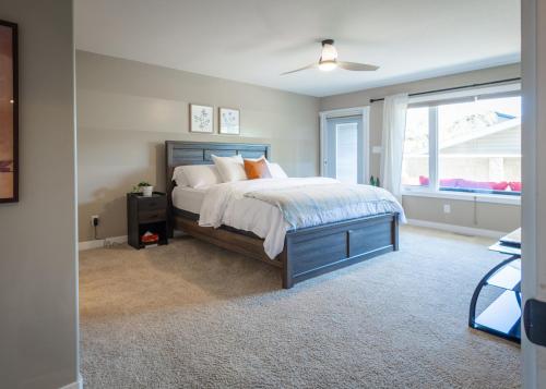 a bedroom with a large bed and a window at Modern comfort in Lethbridge