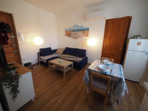a living room with a couch and a table at Le Picaflor YourHostHelper in Hyères
