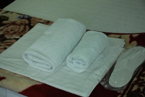 two towels are sitting on top of a table at Sukhrob Barzu Hotel in Bukhara