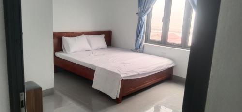 a small bed in a small room with a window at Kì thanh hotel in Thanh Hóa