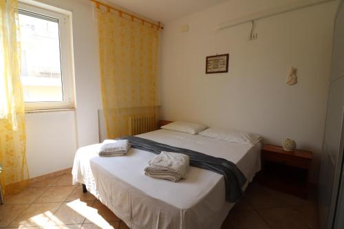 a bedroom with a bed with towels on it at Ayra's House Otranto in Otranto