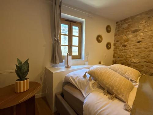 a bedroom with a bed and a window at Le Petit Coin in Saintes