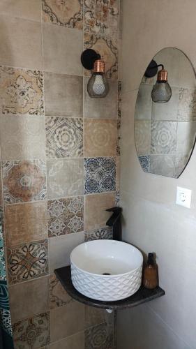 a bathroom with a white sink and a mirror at Pensiunea Luceafărul, Pasul Mestecăniș in Valea Putnei