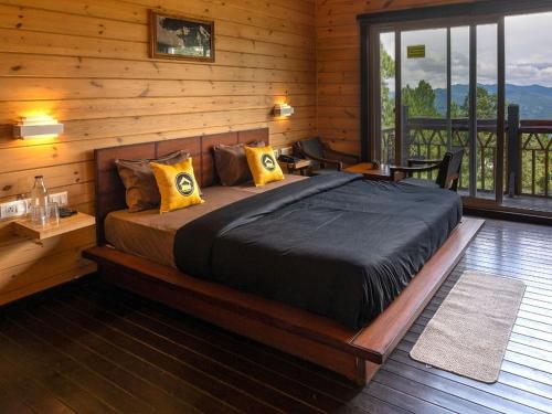 a bedroom with a large bed in a log cabin at The Hosteller Kasar Devi in Almora