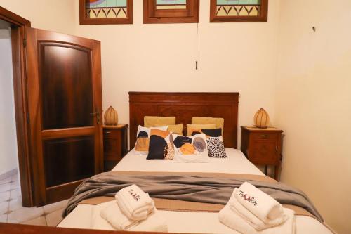 a bedroom with a bed with towels on it at Dimora Cariddi al Centro Storico in Otranto