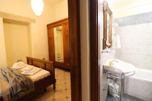 a bathroom with a sink and a bath tub at Dimora Cariddi al Centro Storico in Otranto