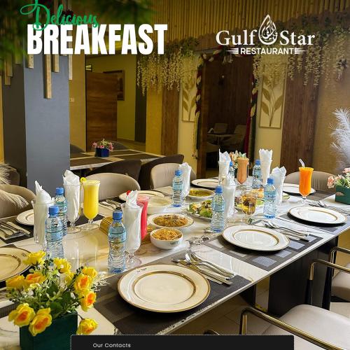 a long table with plates of food and water bottles at Gulf Star Hotel Hargeisa in Hargeysa
