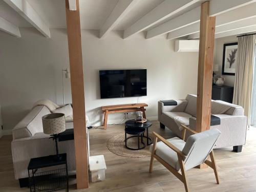 a living room with a couch and a table at Gieters Mooist in Giethoorn