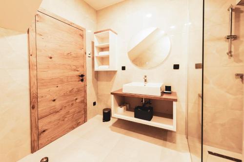 a bathroom with a sink and a shower at Residence Legio XIII Gemina in Ptuj