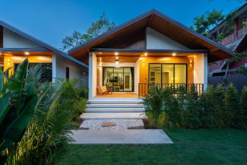 a home with a pathway leading to the front door at Siva Pool Villa in Chaloklum