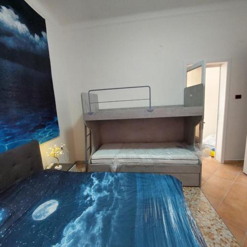 a bedroom with a bunk bed with a painting on the wall at Chiaro di Luna in Crispiano