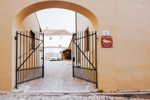 an entrance to a building with an open gate at Residence Legio XIII Gemina in Ptuj
