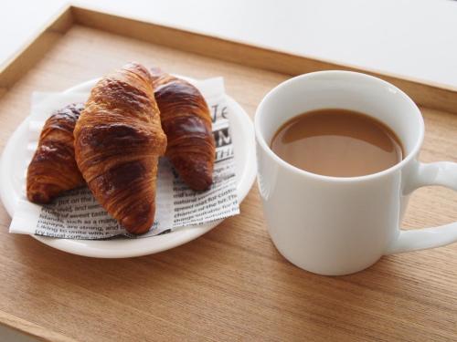 a plate of croissants and a cup of coffee at Atagawa Onsen Blue Ocean in Higashiizu