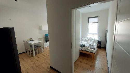 an open door to a living room with a table at MagMar Studio Kluczbork Rynek Premium in Kluczbork