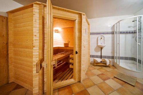 a bathroom with a large wooden room with a tub at La Maison de Joséphine in Risoul