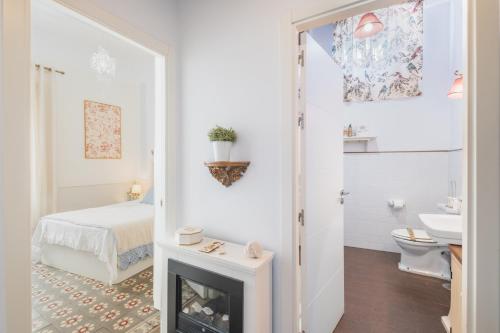 a bedroom with a bed and a fireplace at Palacete de La Alameda - Adults Only- in Cádiz