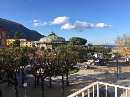 a view of a city with a building and trees at Stella Marina Stabia in Castellammare di Stabia